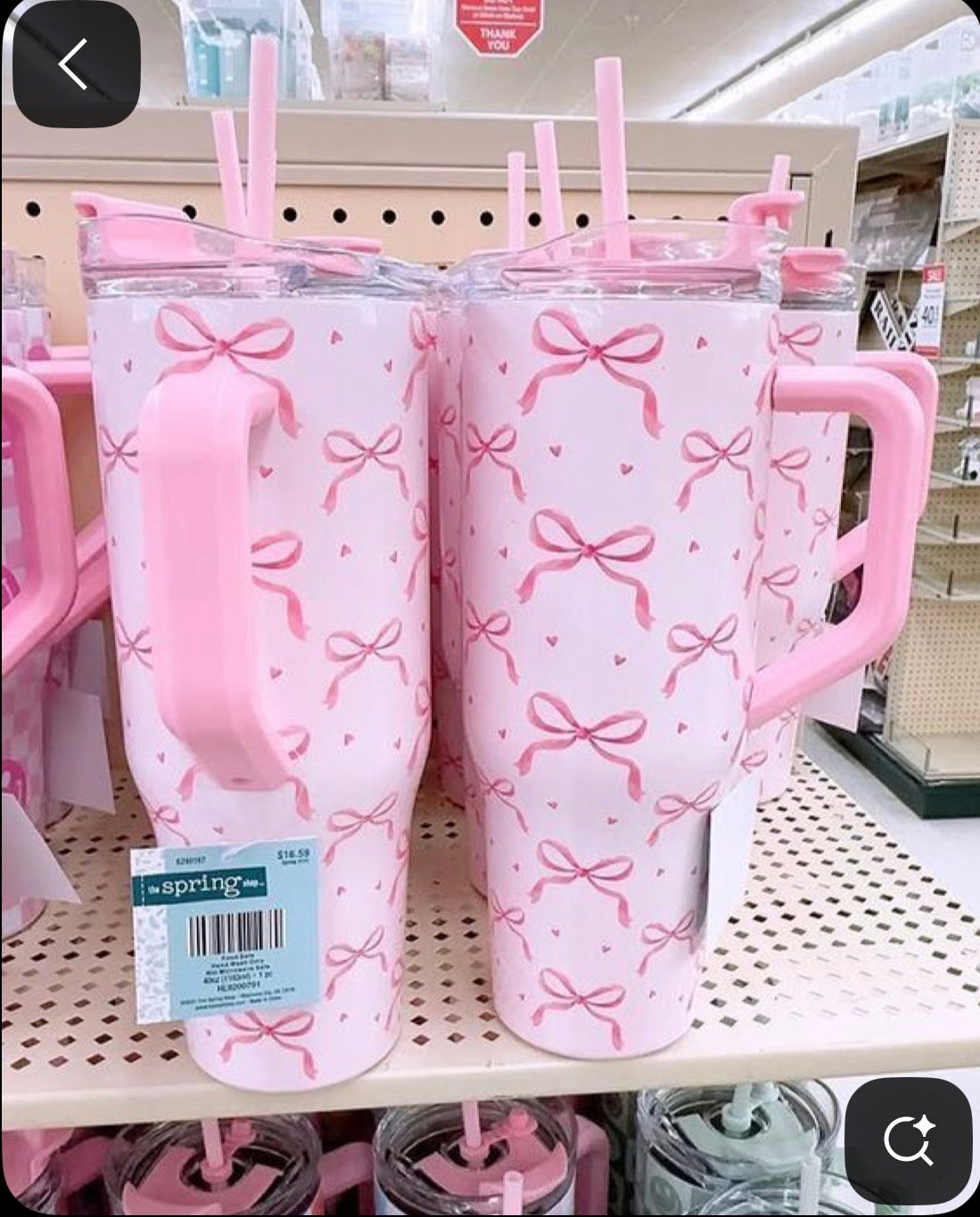 pink handled tumbler with a bow-and-heart print, a clear lid, and a matching pink straw.